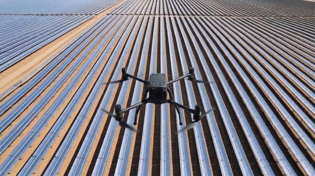 Drone flying over the parabolic trough collectors of a CSP solar field